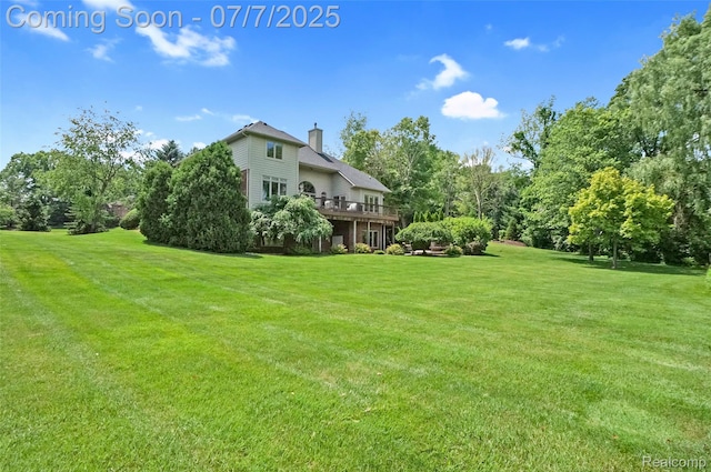 2545 Hartun Dr, Brighton, MI 48114 - view of green lawn with a deck