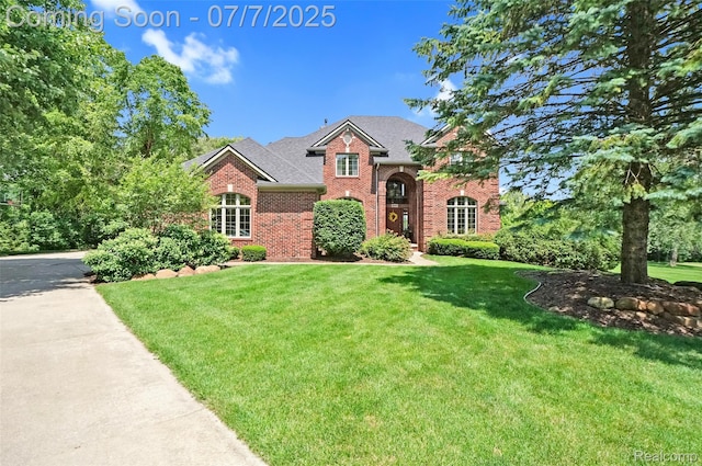 2545 Hartun Dr, Brighton, MI 48114 - view of front of property featuring brick siding, a front lawn, and roof with shingles