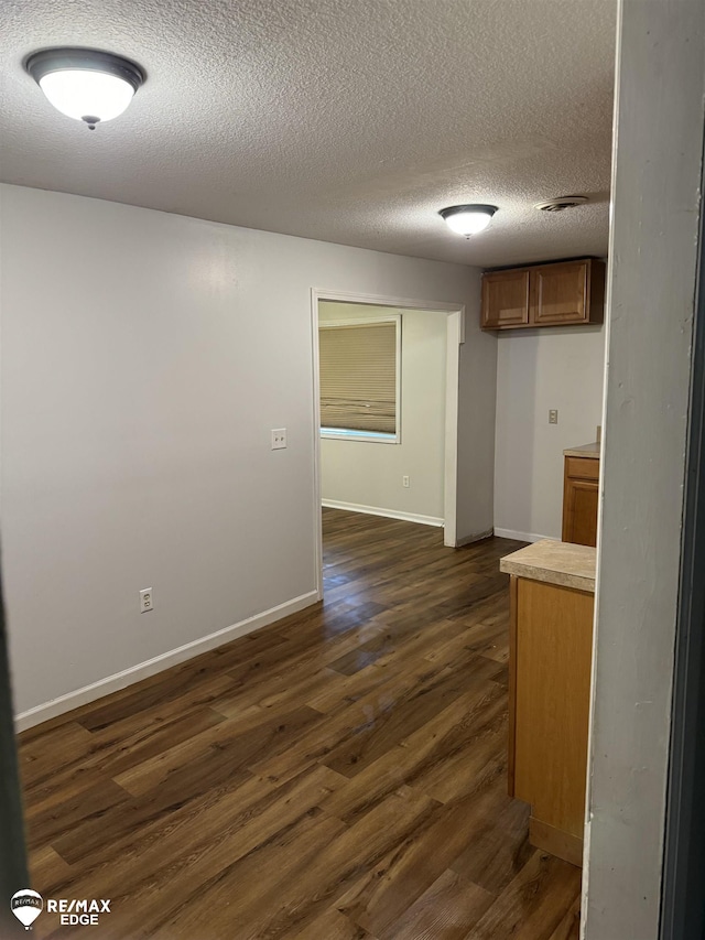 11454 Haven St, Clio, MI 48420 - spare room with dark wood finished floors and a textured ceiling