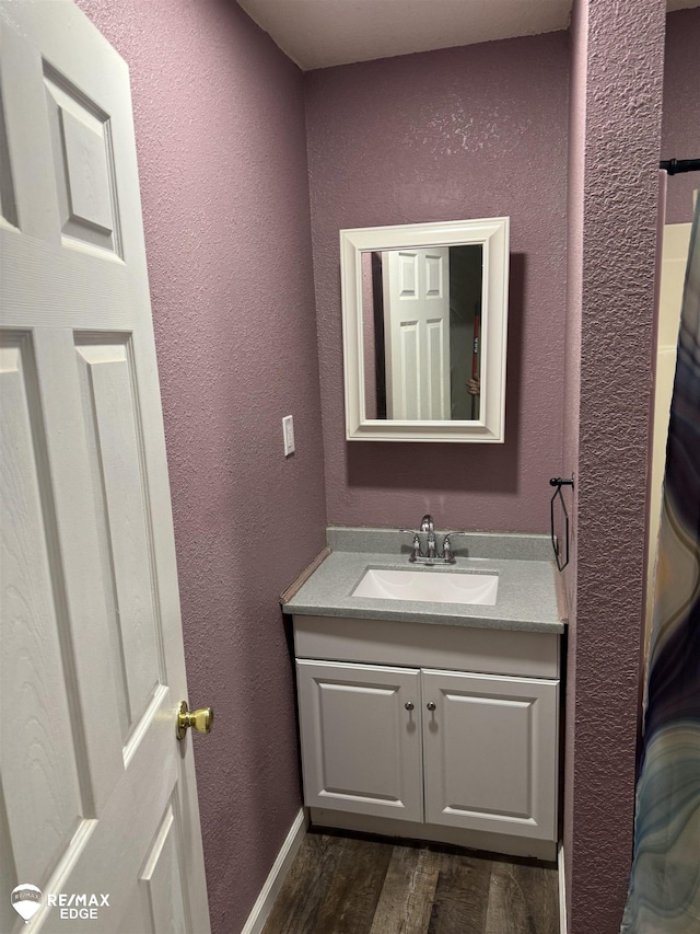 11454 Haven St, Clio, MI 48420 - bathroom with vanity, wood finished floors, and a textured wall