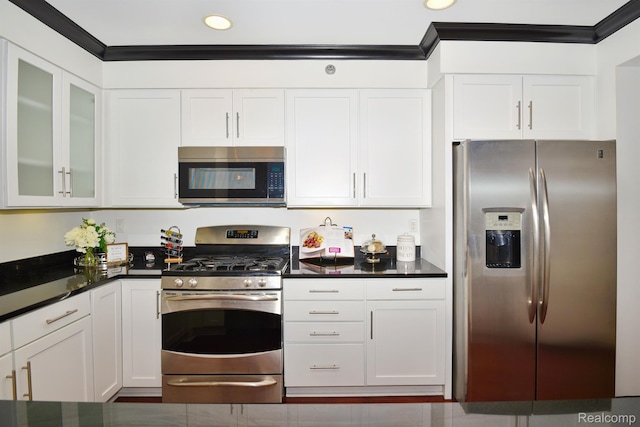 1135 Shelby St Unit 2607, Detroit, MI 48226 - kitchen with appliances with stainless steel finishes, white cabinetry, dark countertops, glass insert cabinets, and recessed lighting