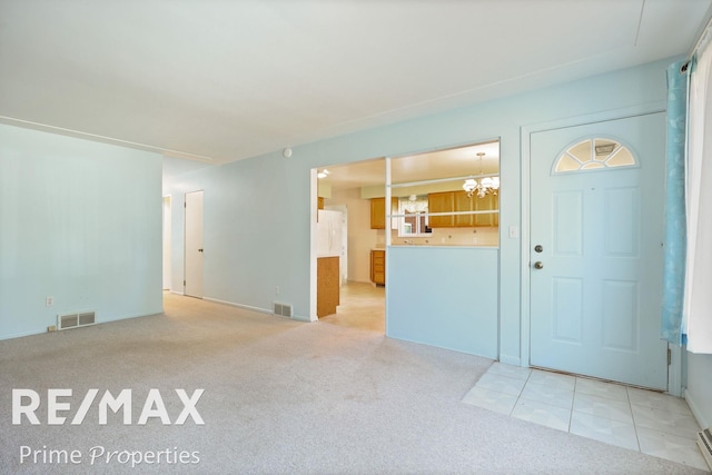 2524 Whitemore Pl, Saginaw, MI 48602 - foyer entrance with a chandelier and light carpet