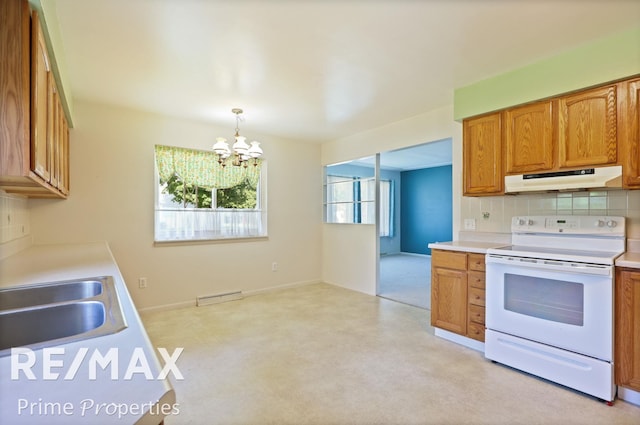 2524 Whitemore Pl, Saginaw, MI 48602 - kitchen with white electric stove, under cabinet range hood, a chandelier, backsplash, and light countertops