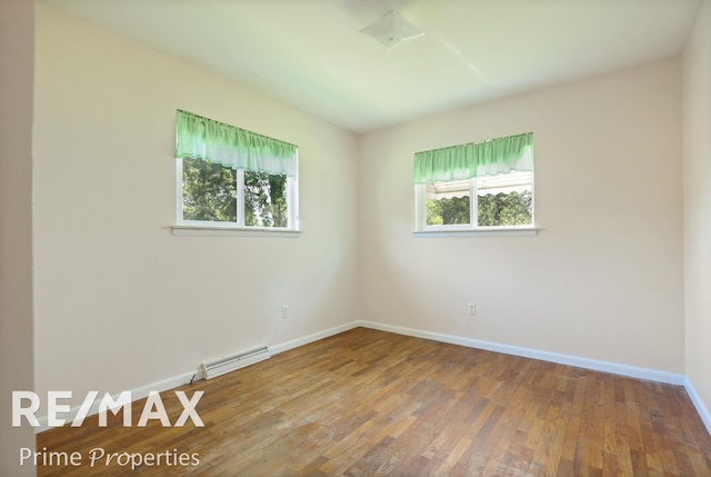 2524 Whitemore Pl, Saginaw, MI 48602 - empty room with a baseboard heating unit and wood finished floors