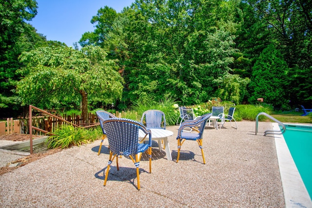 295 N Lakeshore Dr, Holland, MI 49424 - view of patio / terrace featuring view of wooded area and an outdoor pool
