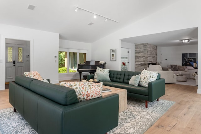 295 N Lakeshore Dr, Holland, MI 49424 - living area featuring track lighting, vaulted ceiling, and light wood-type flooring