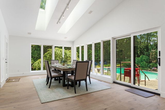 295 N Lakeshore Dr, Holland, MI 49424 - sunroom / solarium with track lighting, a skylight, plenty of natural light, wood-type flooring, and high vaulted ceiling