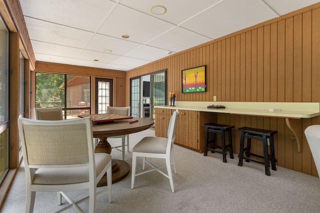 295 N Lakeshore Dr, Holland, MI 49424 - dining area with light colored carpet, wooden walls, and a drop ceiling
