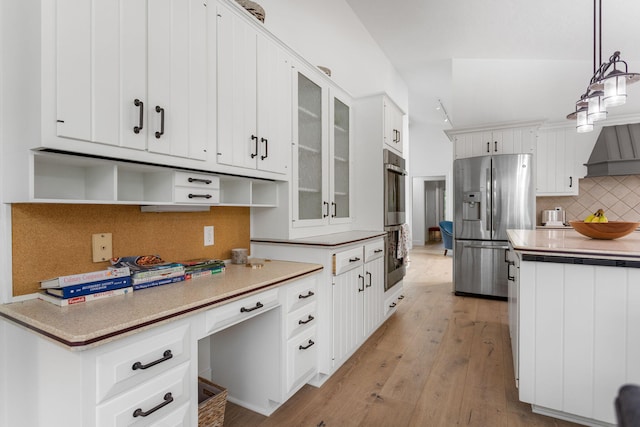 295 N Lakeshore Dr, Holland, MI 49424 - kitchen with appliances with stainless steel finishes, backsplash, light wood-style flooring, hanging light fixtures, and glass insert cabinets