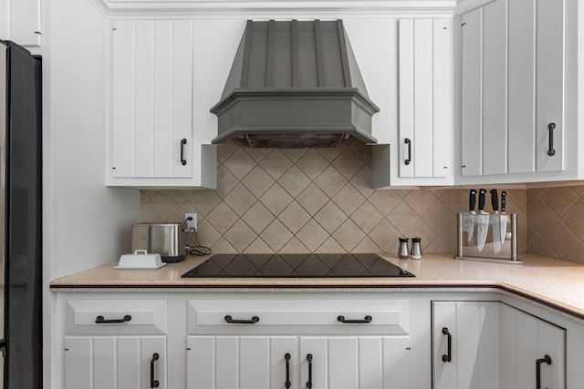 295 N Lakeshore Dr, Holland, MI 49424 - kitchen with custom exhaust hood, black appliances, light countertops, and white cabinets