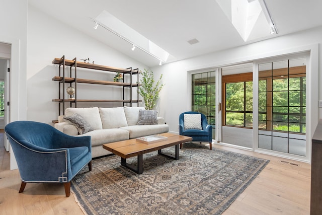 295 N Lakeshore Dr, Holland, MI 49424 - living room with a skylight, vaulted ceiling, and wood finished floors