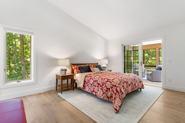 295 N Lakeshore Dr, Holland, MI 49424 - bedroom featuring vaulted ceiling, access to outside, and light wood finished floors