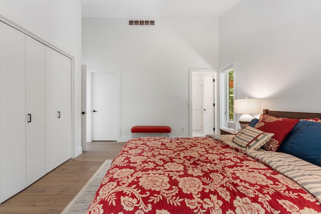 295 N Lakeshore Dr, Holland, MI 49424 - bedroom featuring a towering ceiling and wood finished floors
