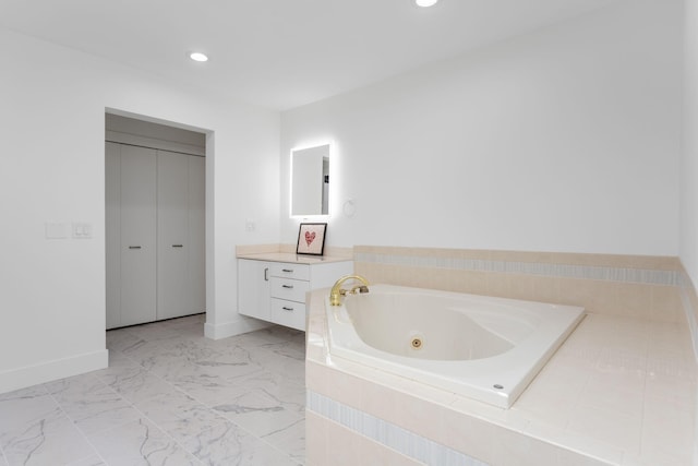295 N Lakeshore Dr, Holland, MI 49424 - bathroom featuring a whirlpool tub, vanity, recessed lighting, and marble look tile flooring