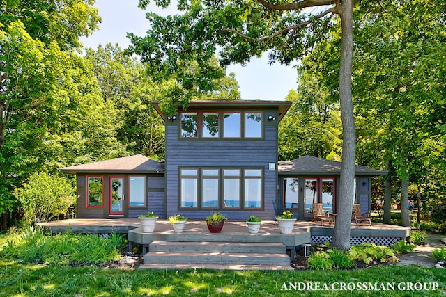 1228 Shore Crest Dr, South Haven, MI 49090 - back of property with a deck, a shingled roof, and french doors