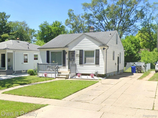 18071 Winthrop St, Detroit, MI 48235 - bungalow featuring a chimney, a front yard, concrete driveway, and a shingled roof