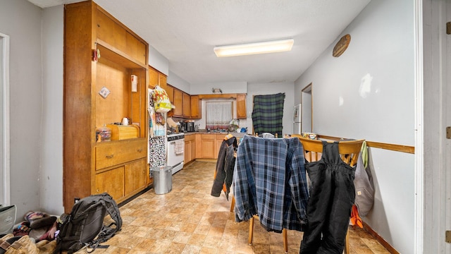 405 5th St, Evart, MI 49631 - kitchen featuring white appliances and stone finish floors