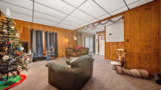 405 5th St, Evart, MI 49631 - living area with wooden walls, carpet floors, and a drop ceiling