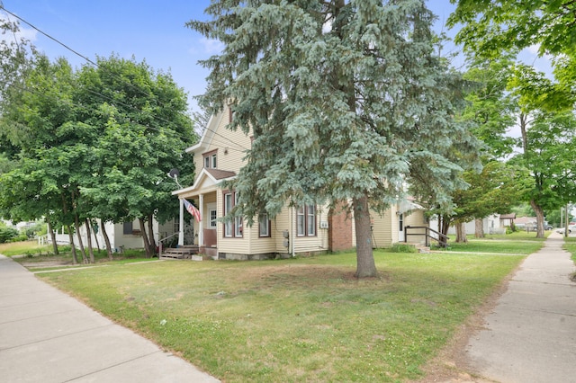 405 5th St, Evart, MI 49631 - view of front of house featuring a front yard and covered porch
