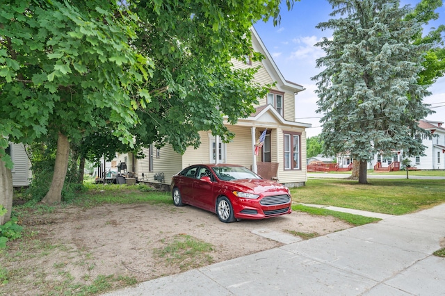 405 5th St, Evart, MI 49631 - view of front facade featuring a front yard
