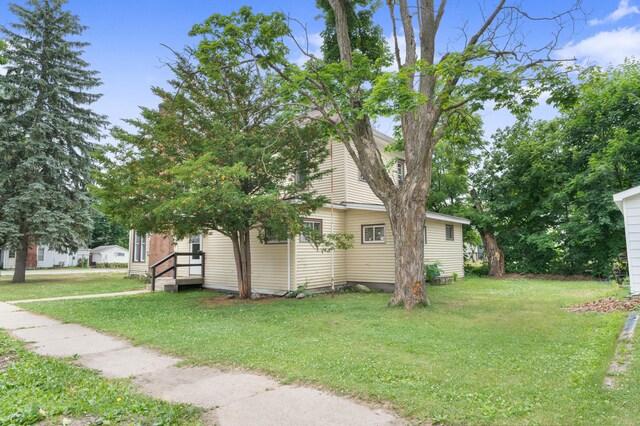 405 5th St, Evart, MI 49631 - view of property exterior with a yard