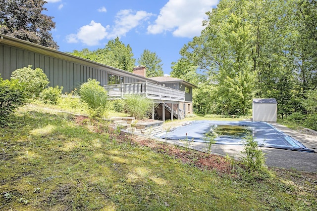 55835 Davis Ln, Dowagiac, MI 49047 - view of pool with stairway, a deck, a storage shed, and a covered pool
