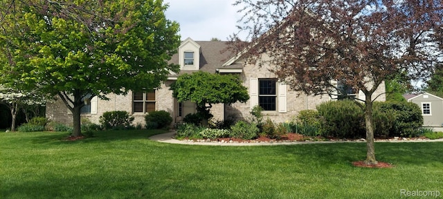 15203 Woodpine Dr, Monroe, MI 48161 - obstructed view of property featuring a front yard and stone siding