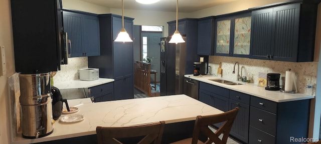 15203 Woodpine Dr, Monroe, MI 48161 - kitchen featuring stainless steel appliances, a peninsula, glass insert cabinets, pendant lighting, and decorative backsplash