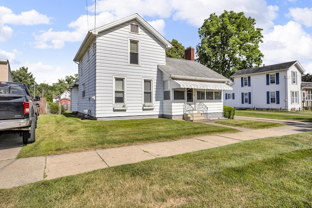 715 Ellery Ave, Jackson, MI 49202 - view of front of property featuring a front lawn, a chimney, and roof with shingles