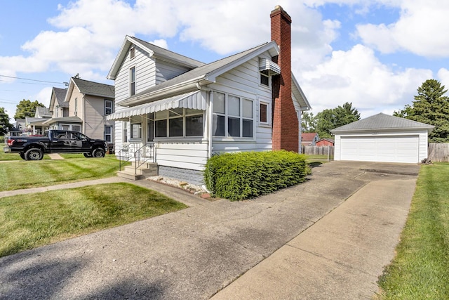 715 Ellery Ave, Jackson, MI 49202 - view of front of property featuring a detached garage, a chimney, and an outdoor structure