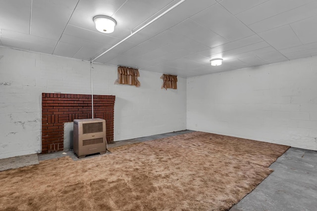 715 Ellery Ave, Jackson, MI 49202 - finished basement featuring concrete block wall, a wood stove, and heating unit