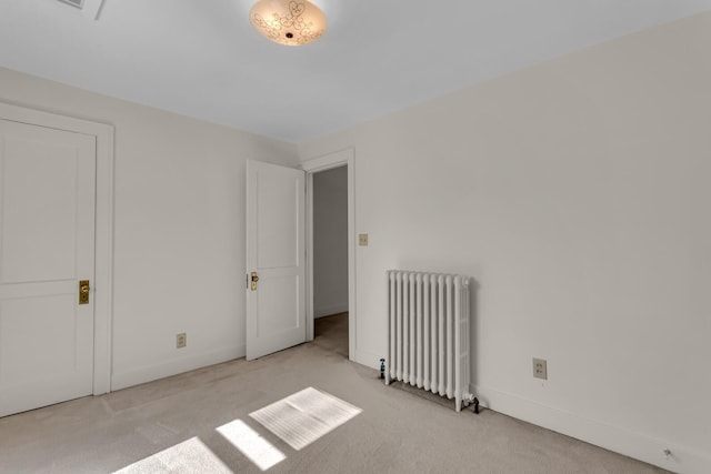 715 Ellery Ave, Jackson, MI 49202 - carpeted empty room with radiator heating unit and baseboards