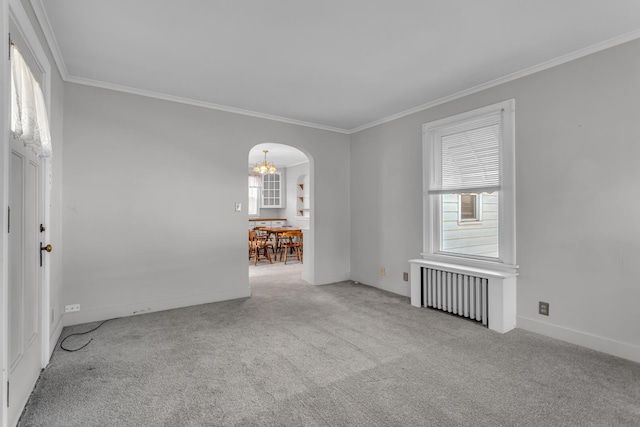 715 Ellery Ave, Jackson, MI 49202 - unfurnished room featuring radiator heating unit, ornamental molding, carpet floors, arched walkways, and a chandelier