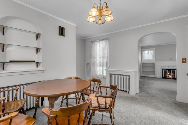 715 Ellery Ave, Jackson, MI 49202 - dining room featuring radiator, carpet flooring, a brick fireplace, crown molding, and arched walkways