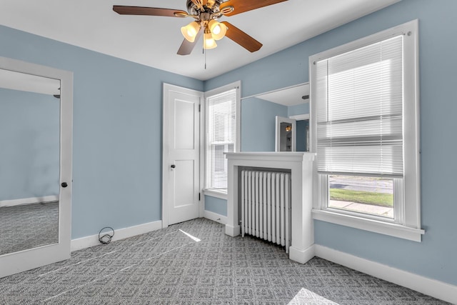 715 Ellery Ave, Jackson, MI 49202 - unfurnished bedroom featuring carpet flooring, ceiling fan, and radiator
