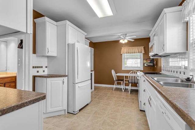715 Ellery Ave, Jackson, MI 49202 - kitchen featuring white appliances, a ceiling fan, white cabinetry, dark countertops, and backsplash