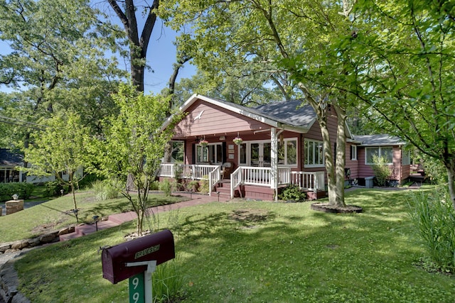 99 Tahoma Trl, New Buffalo, MI 49117 - view of front of home featuring a porch and a front yard