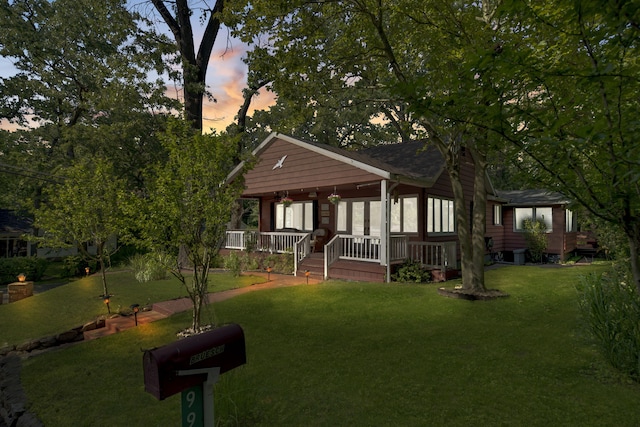 99 Tahoma Trl, New Buffalo, MI 49117 - view of front of home featuring a porch and a front lawn