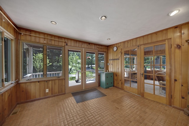 99 Tahoma Trl, New Buffalo, MI 49117 - entryway with french doors, wooden walls, brick patterned flooring, and recessed lighting