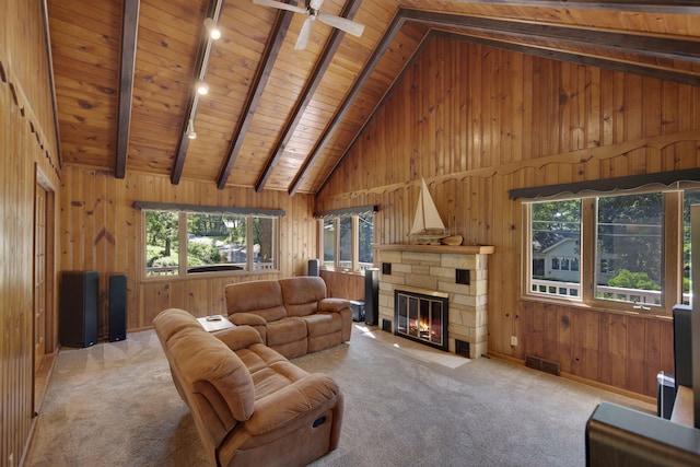 99 Tahoma Trl, New Buffalo, MI 49117 - carpeted living room featuring a wooden ceiling with exposed beams, wooden walls, a fireplace, high vaulted ceiling, and a ceiling fan