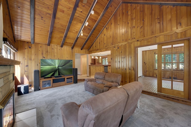 99 Tahoma Trl, New Buffalo, MI 49117 - living room with wood walls, a wood ceiling with exposed beams, high vaulted ceiling, carpet, and a stone fireplace