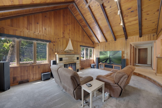 99 Tahoma Trl, New Buffalo, MI 49117 - carpeted living area featuring a wooden ceiling with exposed beams, plenty of natural light, wooden walls, a fireplace, and high vaulted ceiling
