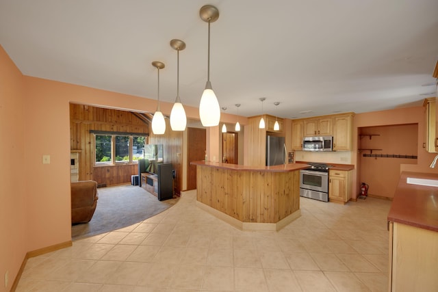 99 Tahoma Trl, New Buffalo, MI 49117 - kitchen with stainless steel appliances, open floor plan, light brown cabinets, decorative light fixtures, and light countertops