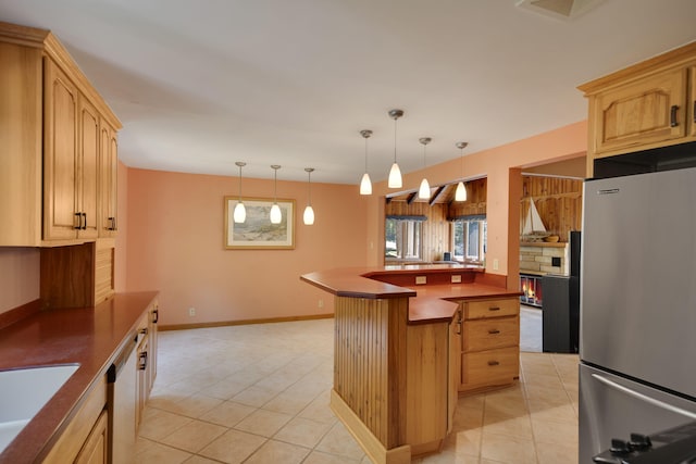 99 Tahoma Trl, New Buffalo, MI 49117 - kitchen featuring appliances with stainless steel finishes, light tile patterned floors, dark countertops, and a kitchen island