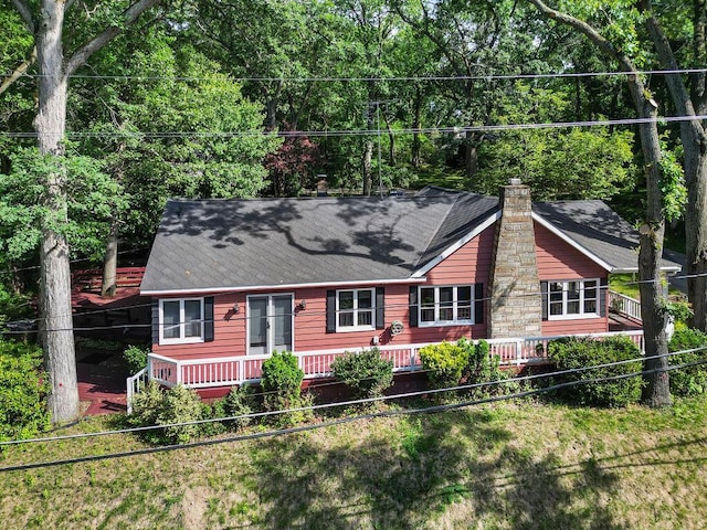 99 Tahoma Trl, New Buffalo, MI 49117 - view of front of property featuring a shingled roof, a chimney, and a wooden deck