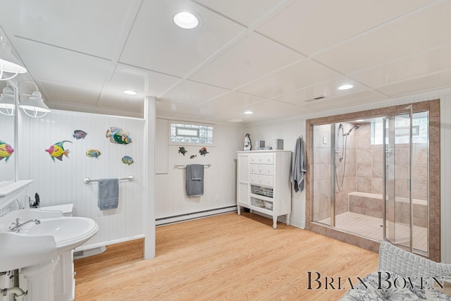 2625 Elmwood Dr, Pierson, MI 49339 - full bath with a baseboard heating unit, a stall shower, wood finished floors, and recessed lighting