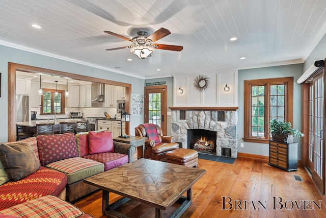2625 Elmwood Dr, Pierson, MI 49339 - living room with recessed lighting, ceiling fan, healthy amount of natural light, light wood-style floors, and ornamental molding