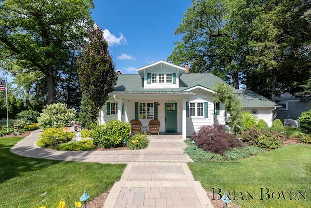 2625 Elmwood Dr, Pierson, MI 49339 - view of front of property with a porch, a front yard, and a chimney
