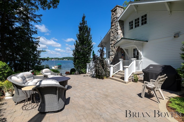 2625 Elmwood Dr, Pierson, MI 49339 - view of patio featuring grilling area, a water view, and outdoor dining space