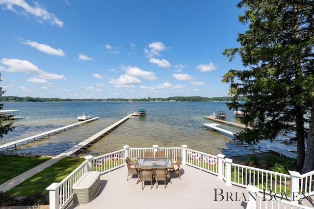 2625 Elmwood Dr, Pierson, MI 49339 - wooden deck with a water view, outdoor dining space, and a dock